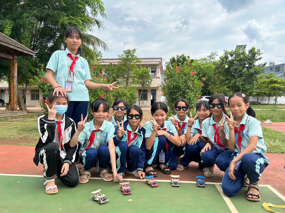 Primary school students in Lingao County, Hainan, with the model cars they built