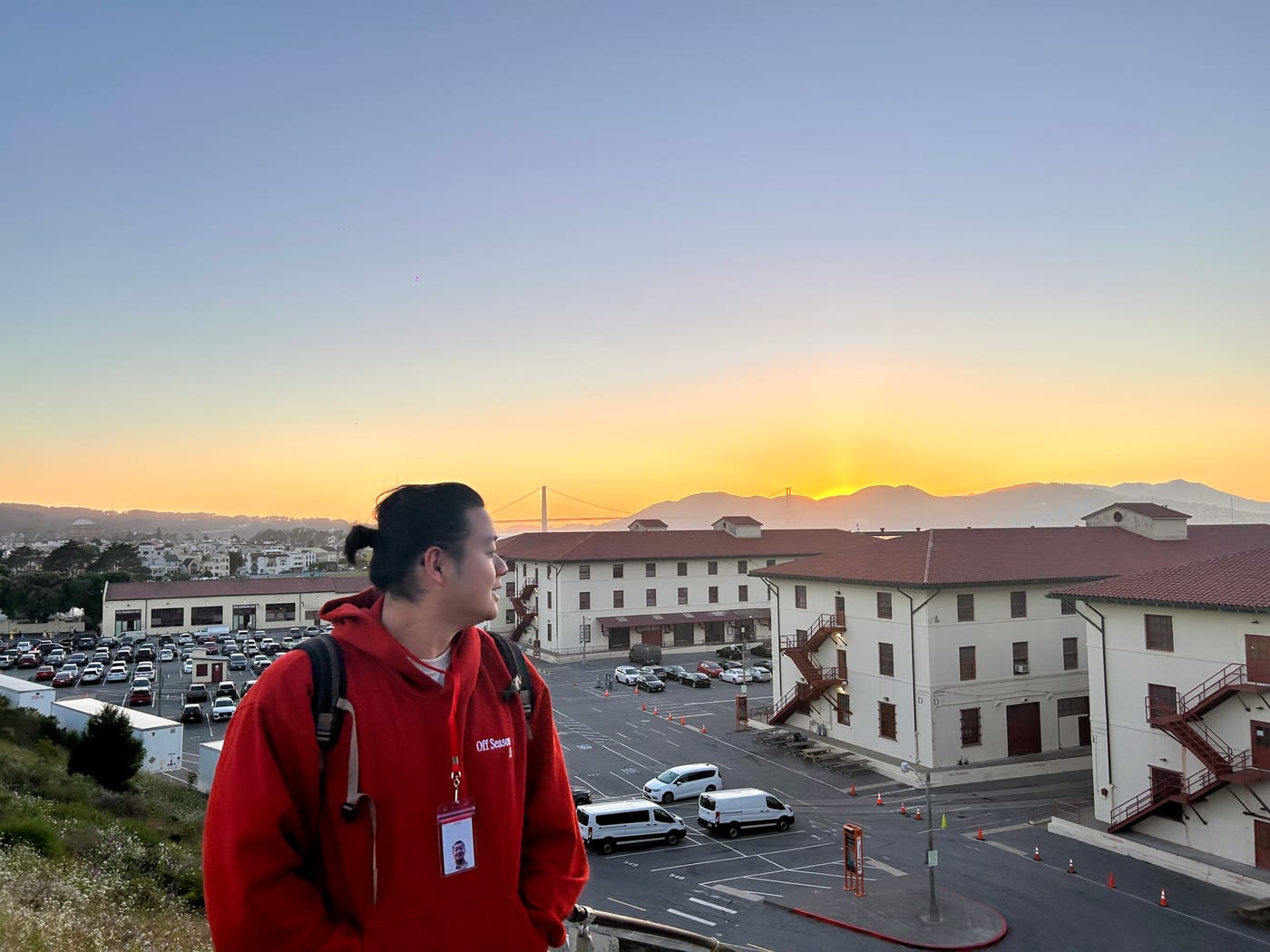 Ju Lin at Fort Mason, San Francisco, with the Golden Gate Bridge at sunset behind